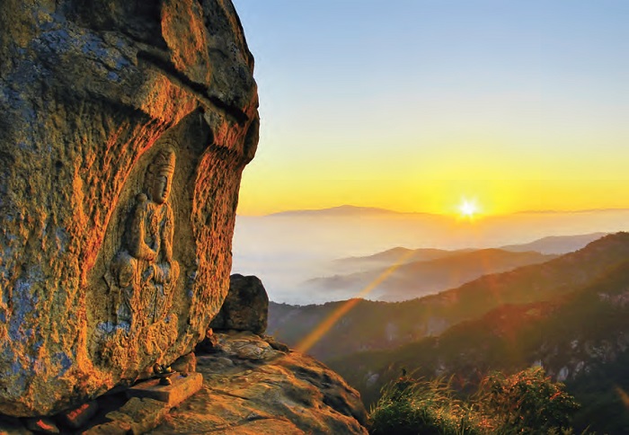 Namsan Mountain in Gyeongju. A seated Buddha image carved on a rock face on Namsan Mountain