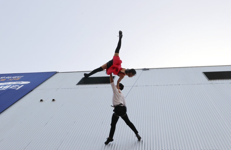 Chiều ngày 12/04, hai vũ công từ nhóm biểu diễn không trùng Dandi có màn trình diễn trên bức tường ngoài của Trung tâm Nhà hát Seoul, quận Jongno-gu (Seoul). 