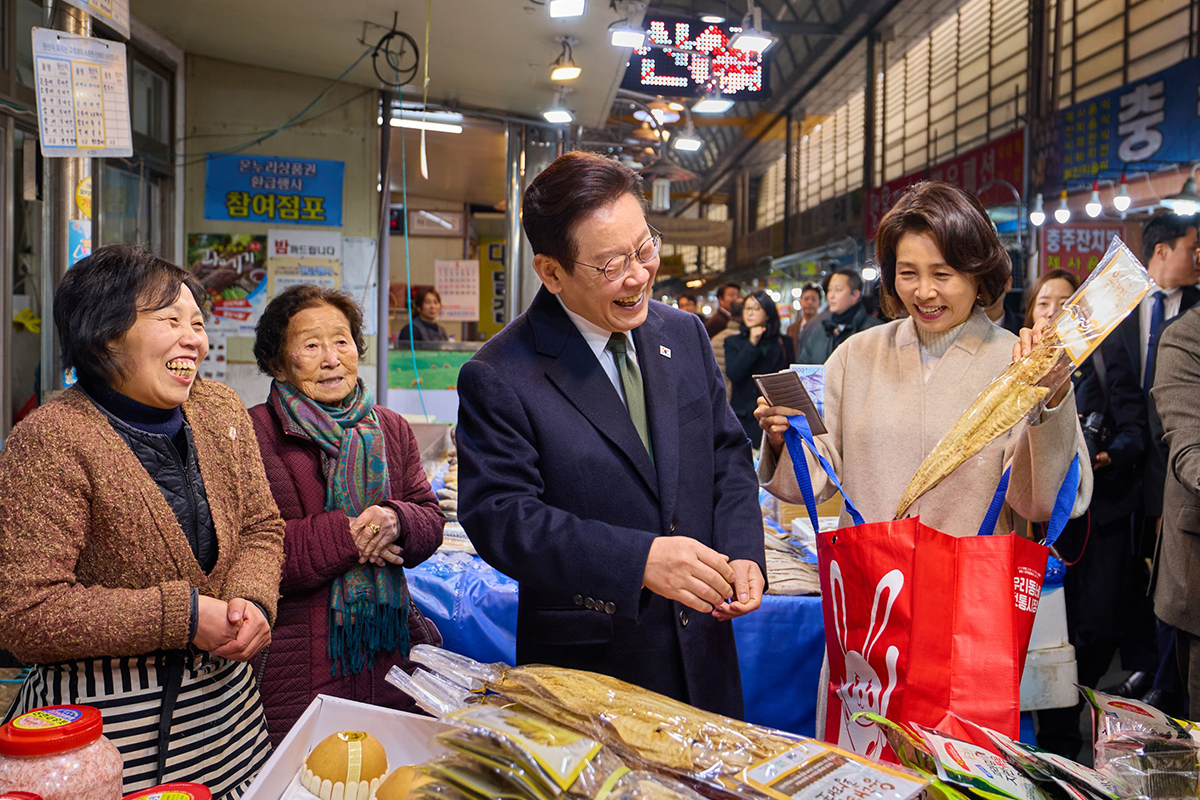 Tổng thống Lee Jae Myung cùng phu nhân Kim Hye Kyung mua các mặt hàng dùng cho lễ cúng tổ tiên khi thăm chợ Muhak ở Chungju, tỉnh Chungcheongbuk-do, ngày 11/2/2026. Ông cũng trực tiếp khảo sát giá cả hàng hóa thiết yếu trong giỏ hàng của người dân. (Ảnh: Nhà Xanh)