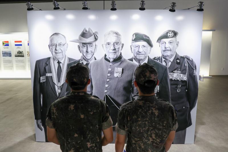 Ng&agrave;y 19/6, tại&nbsp;triển l&atilde;m ảnh &ldquo;Project Soldier - Triển l&atilde;m ảnh tri &acirc;n cựu binh tham chiến trong Chiến tranh Triều Ti&ecirc;n&rdquo; diễn ra tại ph&ograve;ng triển l&atilde;m chuy&ecirc;n đề của Bảo t&agrave;ng&nbsp;Chiến tranh&nbsp;ở quận Yongsan, Seoul, c&aacute;c qu&acirc;n nh&acirc;n đang ngắm&nbsp;bức ảnh ch&acirc;n dung c&aacute;c cựu binh tham chiến trong Chiến tranh Triều Ti&ecirc;n. (Ảnh: Lee Jeong Woo)